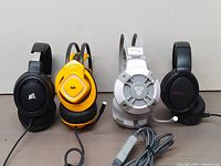 Four wired headsets lined up - Corsair HS35, Monster MH72101, Fantech HG11, Binnune BW02-BT