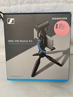 Front of retail box showing Sennheiser MKE 200 Mobile Kit microphone with tripod and clamp setup image.