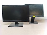 Front view of two computer monitors, Lenovo ThinkVision in front and Planar PLL 2410W behind it