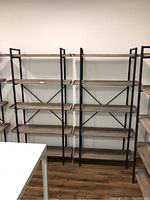 Front view of two assembled bookcases side by side against a wall