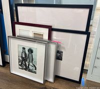Group photo showing two smaller shadow box frames with black and white photographs and one larger Pottery Barn gallery frame with oversized mat.