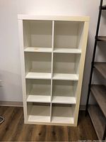 Front view of white shelf unit with 8 cubbies showing clean white finish and structure.