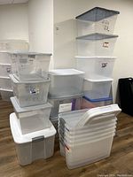 Overall view of stacked Sterilite bins showing different sizes and lid colors