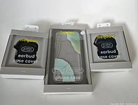 Three items in original packaging: one clear iPhone 12 case with abstract mint green print, two black earbud case covers for Apple AirPods Pro Gen 1 & 2, all by Heyday.
