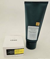 Kristin Ess hair mask tube in dark green with white label, COSRX cream box visible.