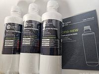 Three Crystala white cylindrical water filters with black labels showing model and replacement info.