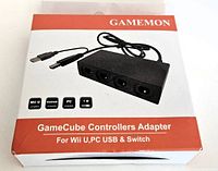 Box showing GAMEMON GameCube controller adapter for Wii U, PC USB & Switch compatibility, featuring four controller ports and 1.8m cable length.