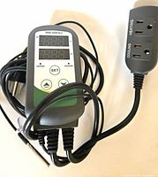 Image showing the Inkbird smart thermostat device with digital screen, control buttons, dual heating and cooling outlets, plug, and attached temperature sensor probe cable.