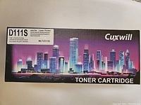 Photo showing the front of one boxed Cuxwill MLT-D111S toner cartridge with cityscape graphic and compatible printer models listed.