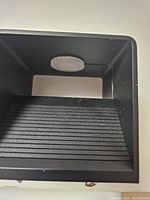 Close-up image showing the interior and ribbed surface of the black modern LED wall sconce fixture