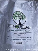 Photo of white woven bag containing barley straw, showing Build a Soil logo and product information.