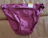 Front view of a single purple amethyst bikini-style women's underwear by Charter Club, showing smooth fabric and trimmed edges with a tag attached.