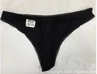 Single black cotton panties with lace trim on white background, showing tag with UPC and style number.