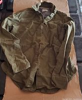 Front view of the women's green buttoned shirt by Hurley, showing buttons and collar with patterned inner lining.