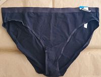 Front view of size XL Jenni women's hi-cut bikini underwear in deep black, showing smooth fabric and cut style with tags.