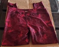 XPB Pro red marbled 3/4 length women's yoga legging pants folded showing front side.