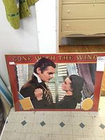 Framed Gone with the Wind movie poster measuring approx 20x28 showing the main characters with a red border and title.