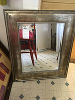 Front view of the wide framed beveled mirror showing the overall size and frame detail.