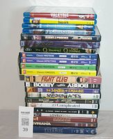 Stack of 19 DVD and Blu-ray movies showing a mix of titles including classic collections and individual films such as Fight Club, Smoking Aces, and Bobby.