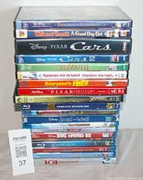 Stack of kids movies Blu-ray and DVD cases showing various titles and colors, all appearing clean and well-kept.