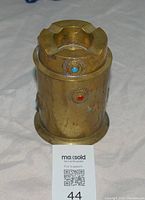 Single assembled brass ashtray with decorative stone inlays and vintage patina.