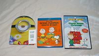 Front view of Minions metal case, Charlie Brown Blu-ray 'It's The Great Pumpkin Charlie Brown' and Charlie Brown DVD 'A Charlie Brown Christmas'