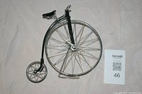 Front and side angle photo of the Penny Farthing bicycle decorative piece showing the large front wheel, smaller rear wheel, and stand.