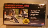 Box showing UltraLite Bi-fold Pet Ramp with product features and dimensions 62 x 16 x 4 inches, made in USA, holds over 200 lbs.