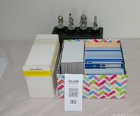 Two boxes of trivia cards, one with white cards labeled Rock and Roll Trivia, the other with colorful backs, likely the Warner Bros. cartoon trivia cards.