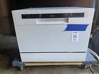 Front view of the white Home portable dishwasher with closed door showing the control panel on top.