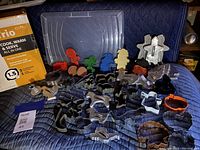 All cookie cutters arranged on quilted surface with Crock-Pot box visible on the left