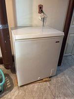 Frontal view of the white Dylis chest freezer showing overall condition and dimensions relative to the surrounding area.