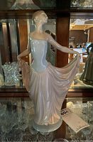 Front angle showing the dancer's pose, dress colors, and glossy porcelain surface