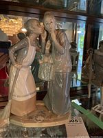 Front view of the figurine showing both figures and base details