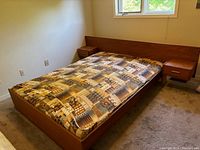 Photo of assembled double size Mid-Century Modern bed with built-in side tables, mattress and bedding on the frame showing overall design