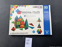 Box front showing Magna-Tiles logo, colorful tile illustrations and product overview for a 32-piece set.
