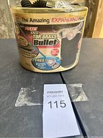 Photo of container showing brand and product features including Top Brass Bullet and Bullet Shell casing.