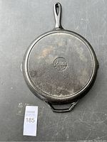 Top-down photo of Lodge cast iron pan, showing bottom with Lodge logo and handle configuration.