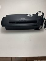 Top view of black Intimus electric paper shredder showing paper feed slot and control button.