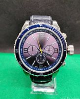 Front view of the quartz wristwatch showing dial, bezel, and leather strap.