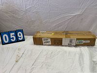 Full view of sealed cardboard box with lot ID card