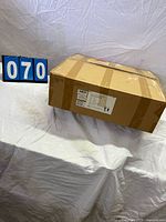 Sealed cardboard box marked lot 070