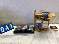 Stack of DVDs on table with lot number card