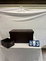 Ottoman with lid on, one fabric drawer removed and placed beside