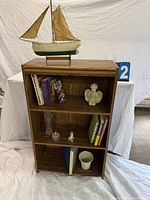 Front view of bookcase loaded with books and décor