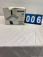 Boxed Broan 678 ventilation fan with light, front panel