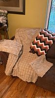 Throw quilt, duvet cover and pillow shams displayed on couch