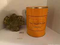 Tin and dish on shelf showing overall lot