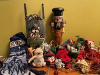 Group shot shows nutcracker, tin sleigh, stocking, ornaments