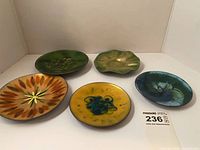 Group view of all five enamel plates front side